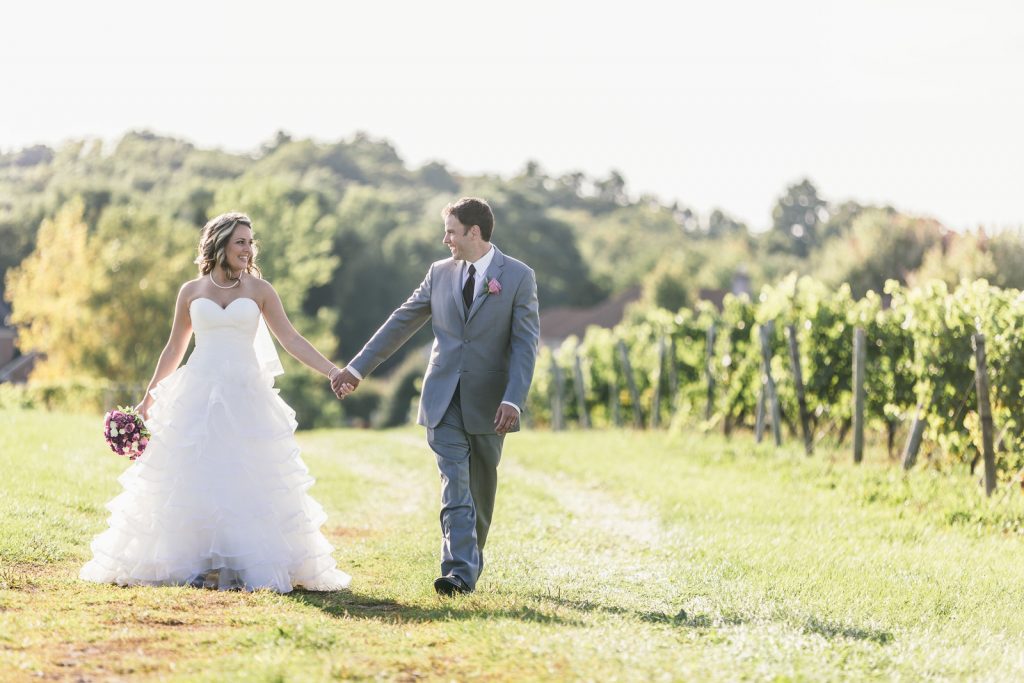 Bride and groom in the vineyard, Wedding Ceremonies and Receptions at Casa Larga Vineyards