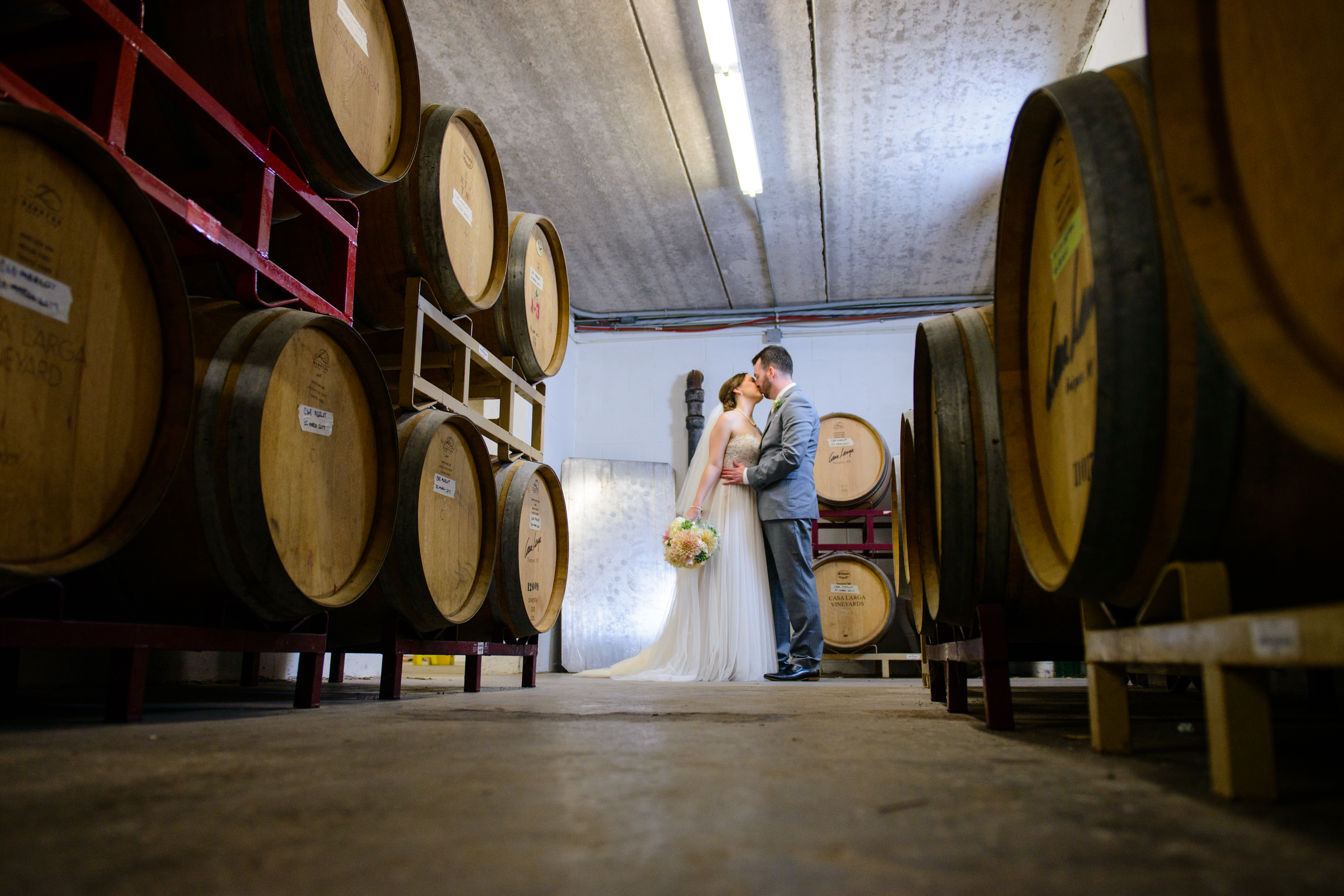 Couple in the Cellar, Wedding Ceremonies and Receptions at Casa Larga Vineyards