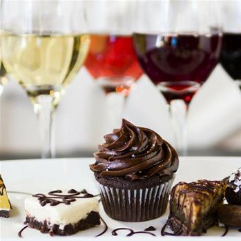 Cupcakes and sweets with varying glasses of wine