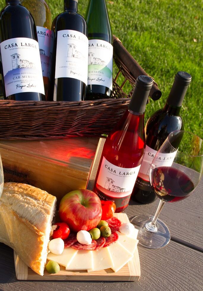 Varying Casa Larga Wines in wicker basket, Fruit and Cheese at Casa Larga Vineyards